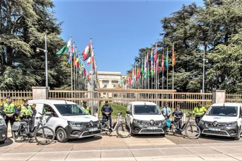 Electric vehicles can be seen standing in front of the Peace Gate of the Palais des Nations.
